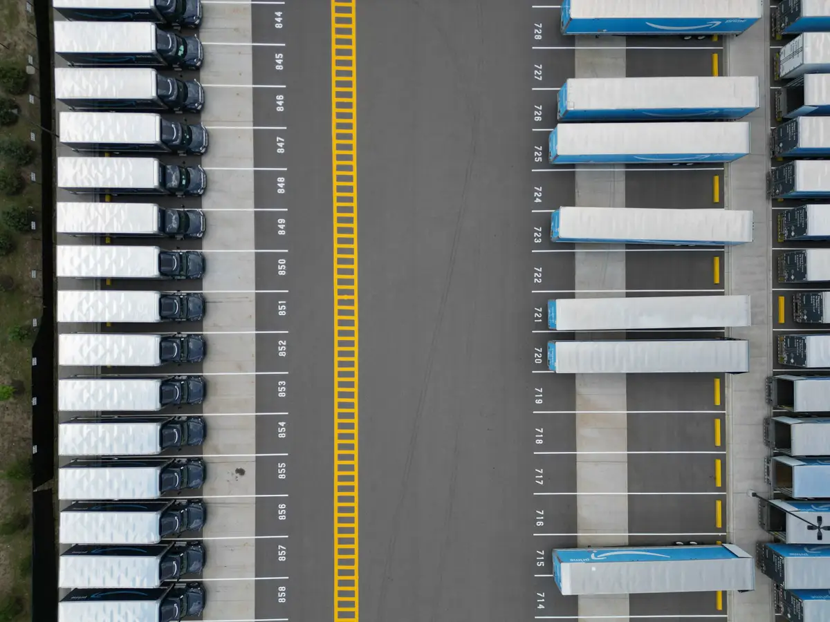 Trailers parked in rows at a logistics yard, seen from above